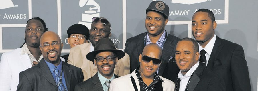 Group poses for photos at awards gala.