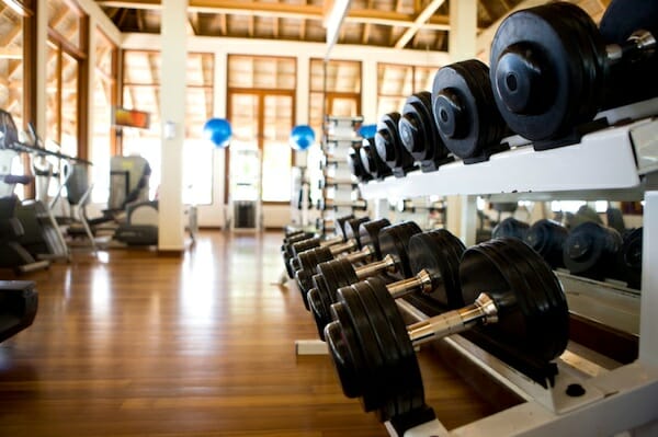 Image of a gym looking at a row of free weights.