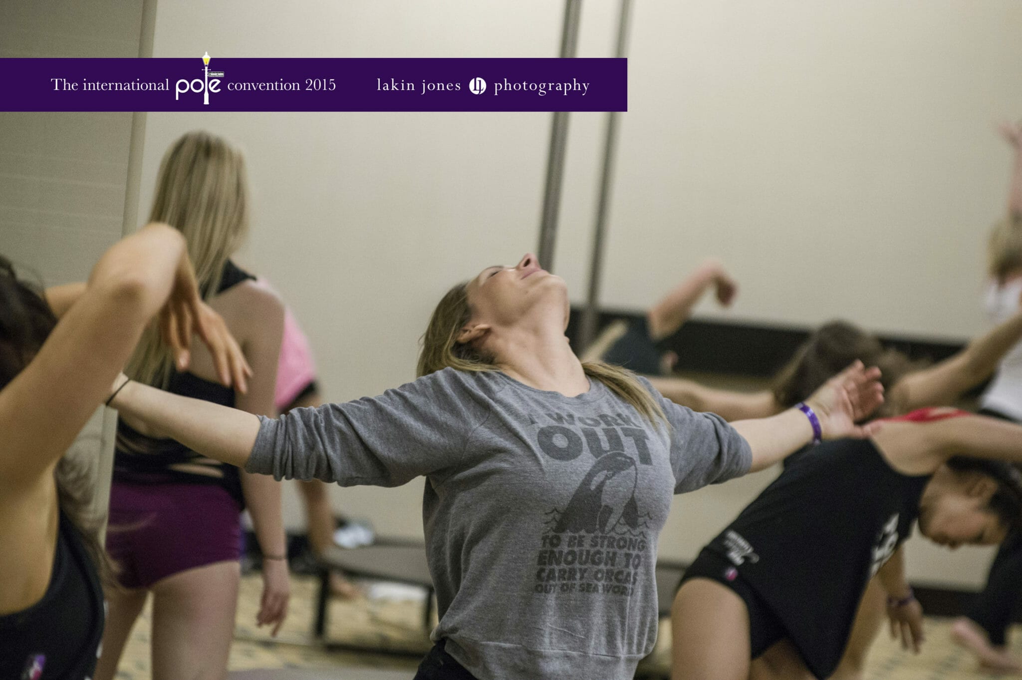 Workshop participants stretch and flow during a PoleCon workshop.