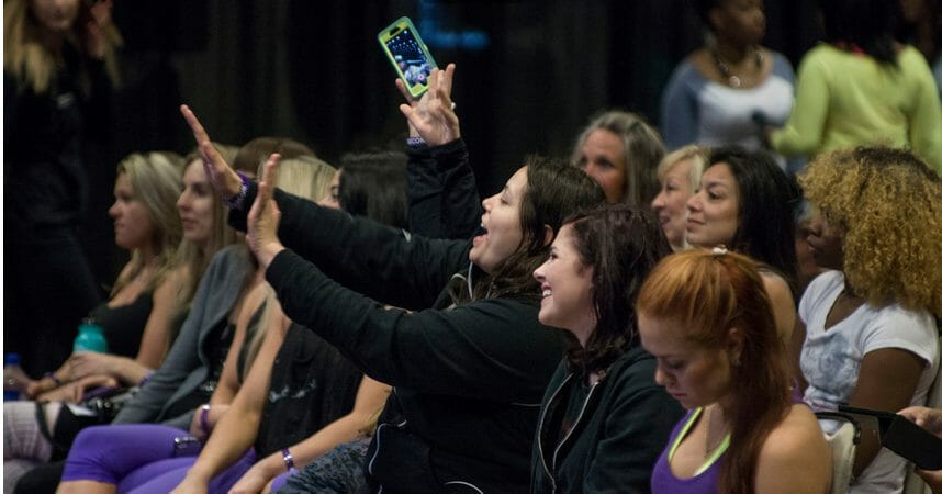 PoleCon audience cheering and taking pictures of the showcase.