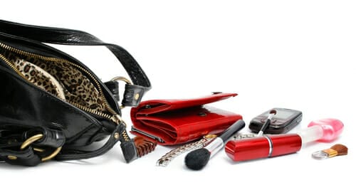 Dumped out purse with makeup, wallet, nail polish.