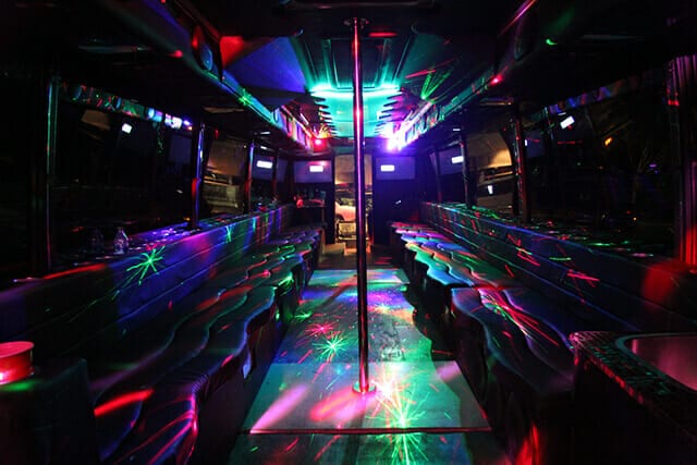 Empty luxury party bus with a pole in the center.