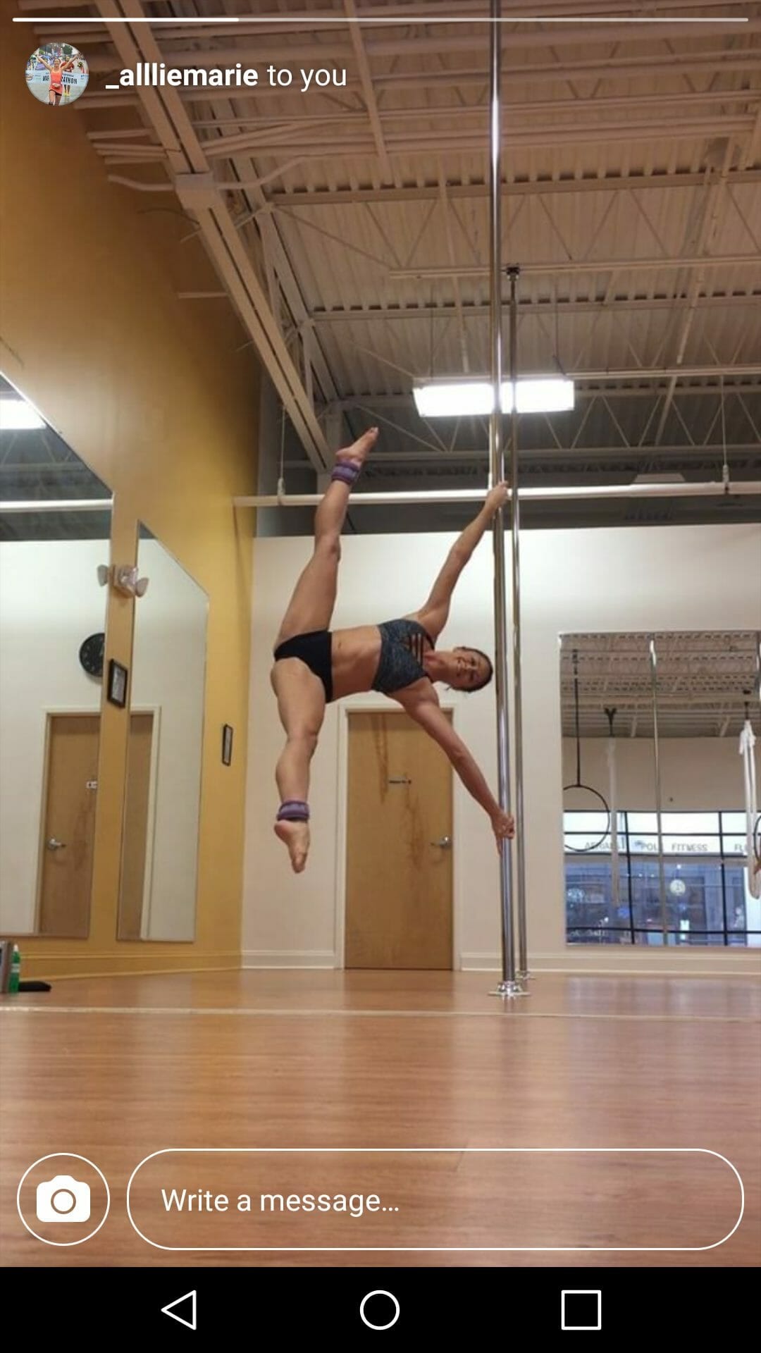 Screenshot of pole dancer executing an iron-X