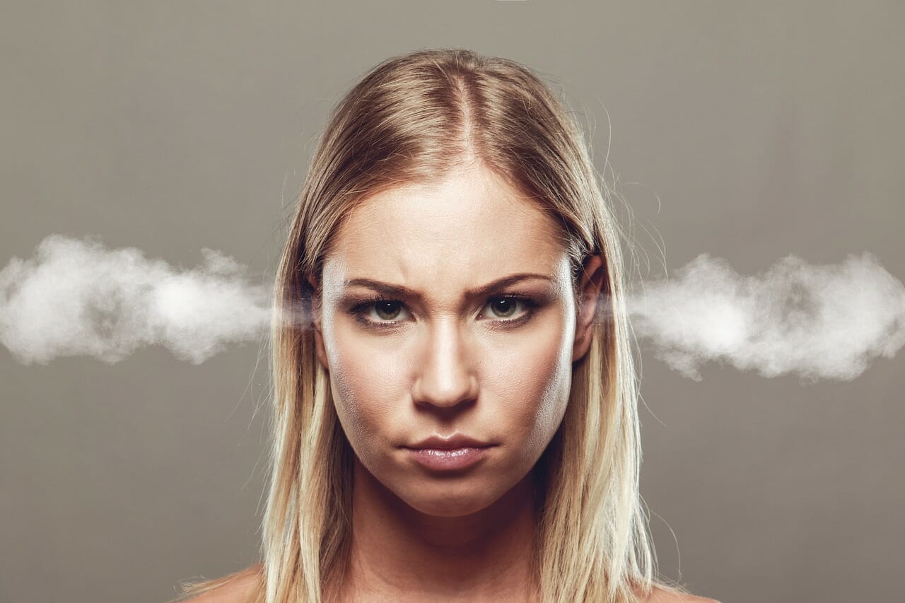 individual staring angrily at the camera with smoke coming out of her ears.