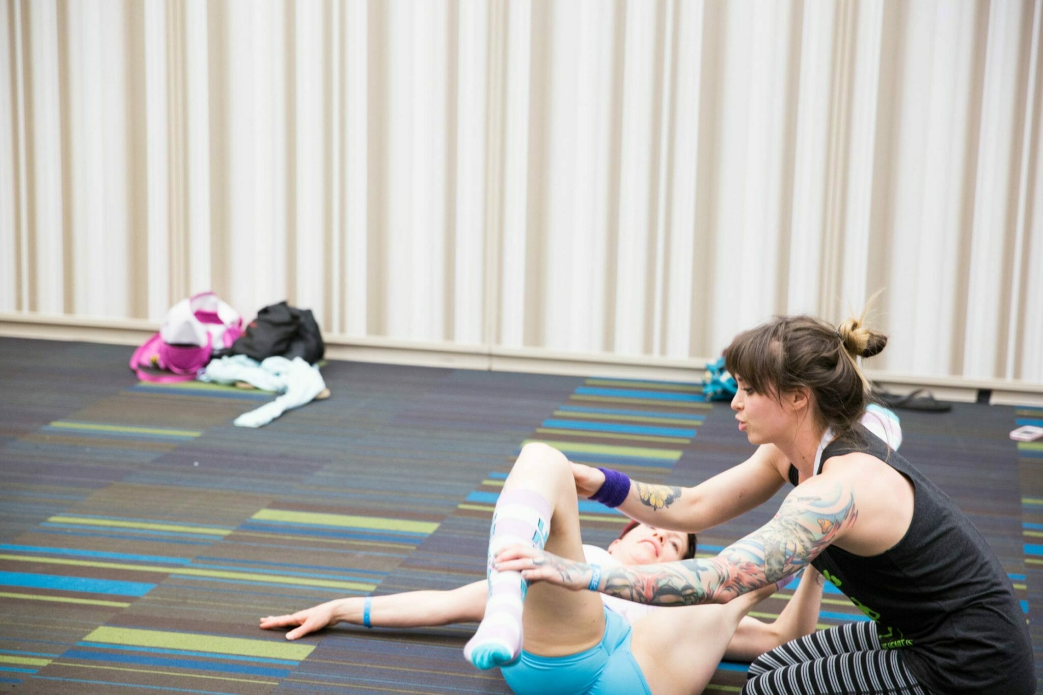 teacher helps a student stretch