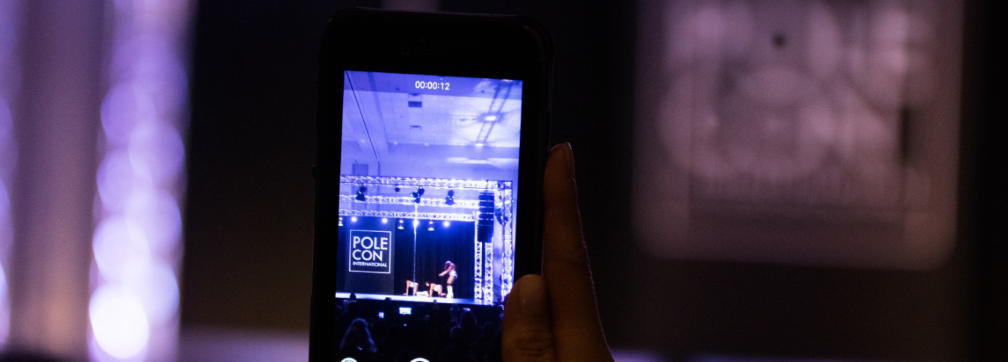 A participant records the PoleCon stage at PoleCon 2018