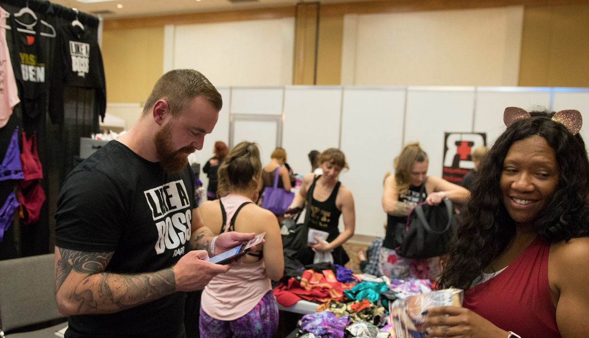 Customers checking out at a vendor booth at PoleCon