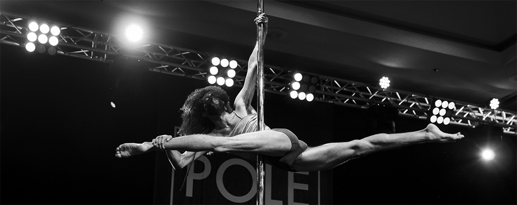 Pole dancer performs chopsticks on stage.