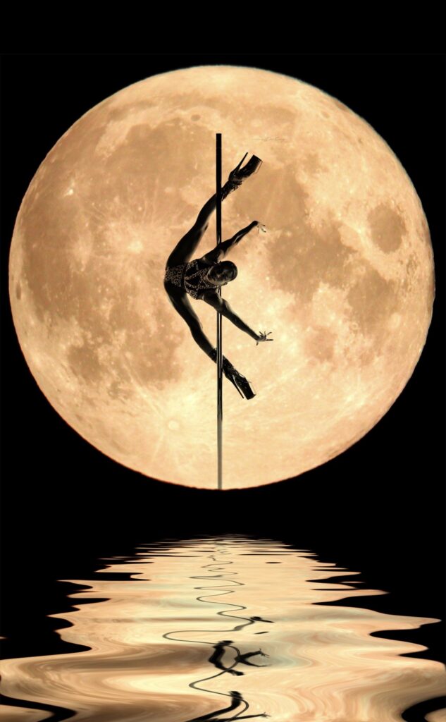 Lisel does a spatchcock pole move in front of a moon 