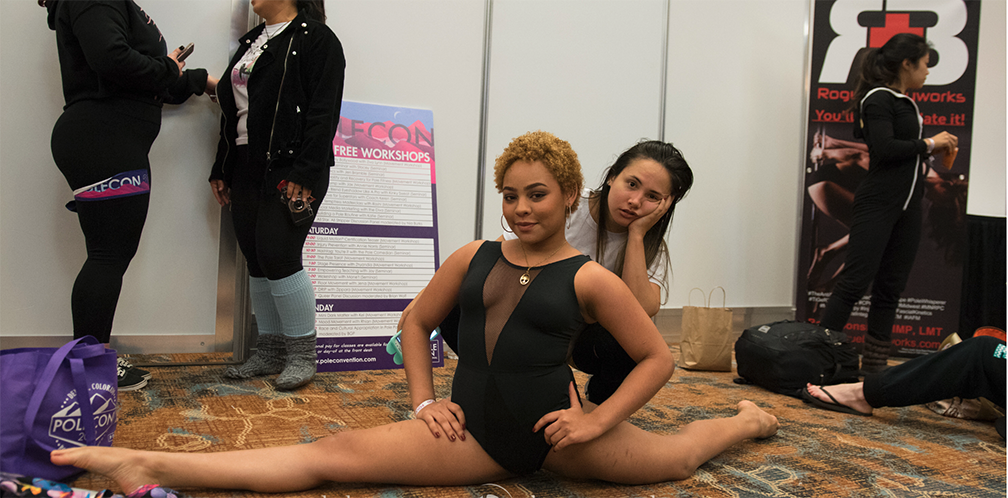 student doing the splits before PoleCon 2019